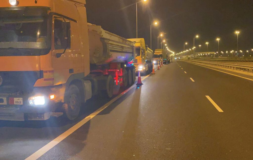 a truck is parked on a highway at night.