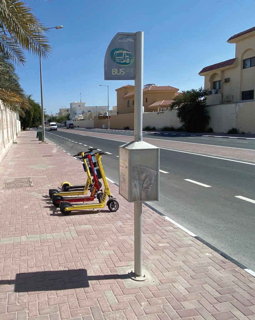 two scooters are parked on the side of the road.
