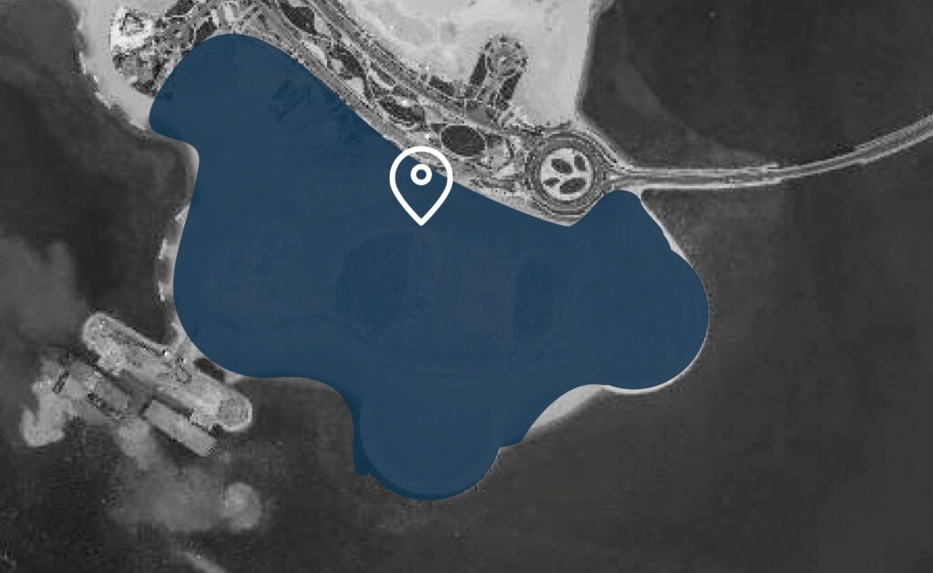 a black and white image of a lake with a marker on it.