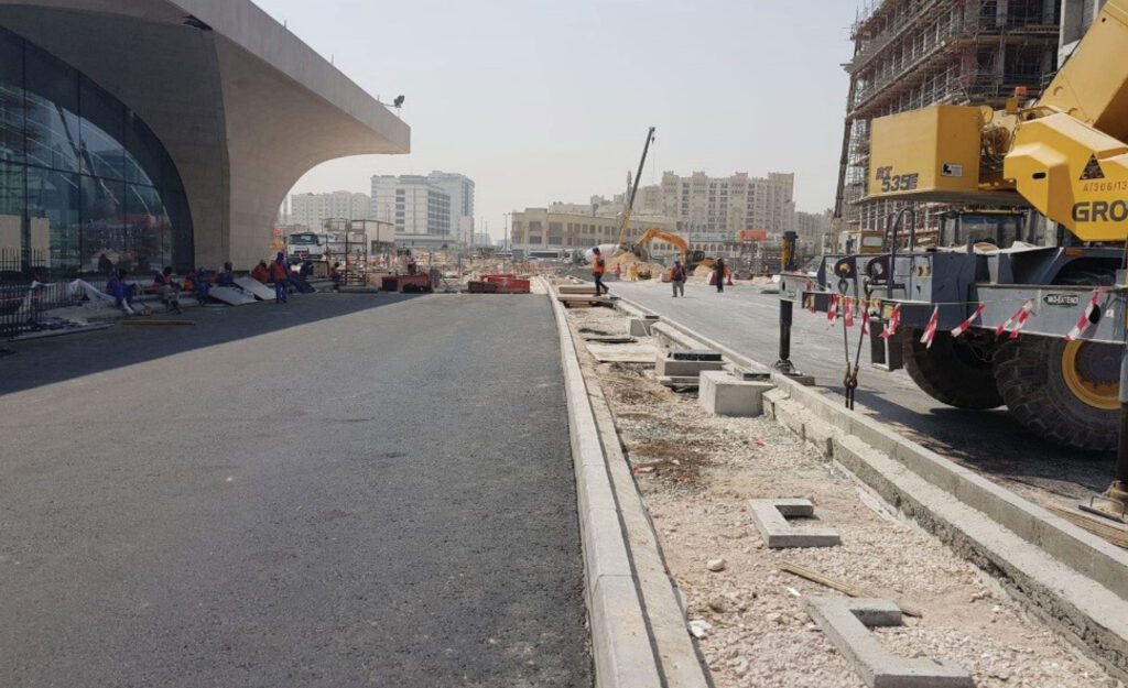 a construction site with a bulldozer on the side of the road.