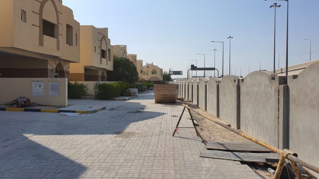 a street in a residential area is under construction.
