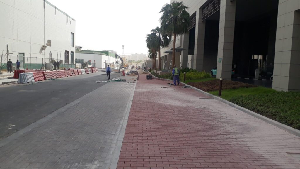 a sidewalk is being constructed in front of a building.