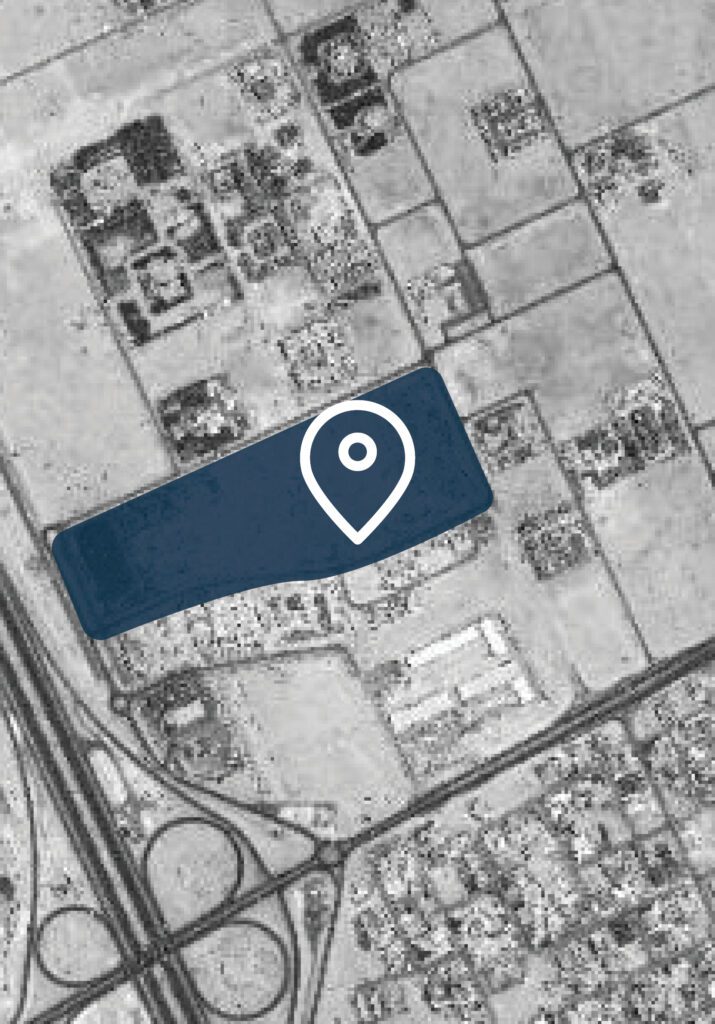 a black and white image of a field with a blue pin on it.