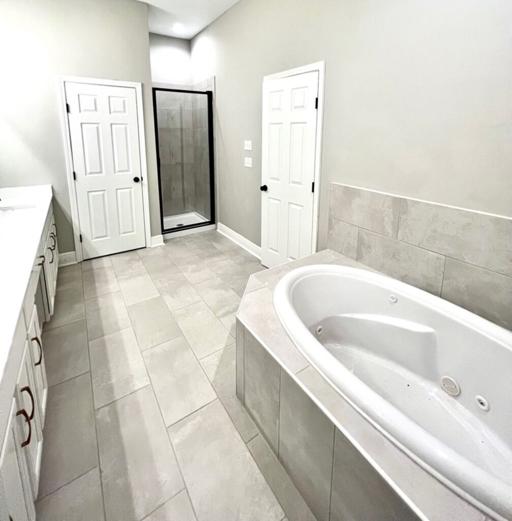 a bathroom with a large tub and shower.