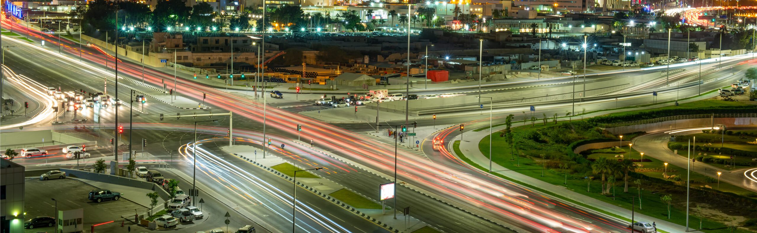 a city at night with a lot of traffic.