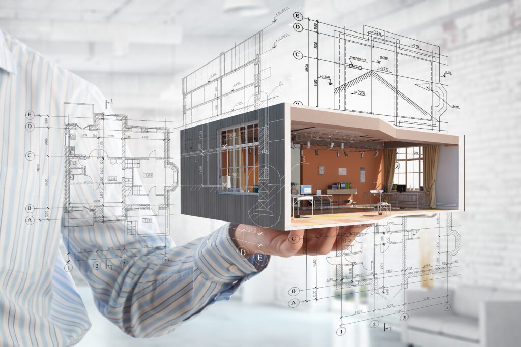a man holding up a model of a house with blueprints.