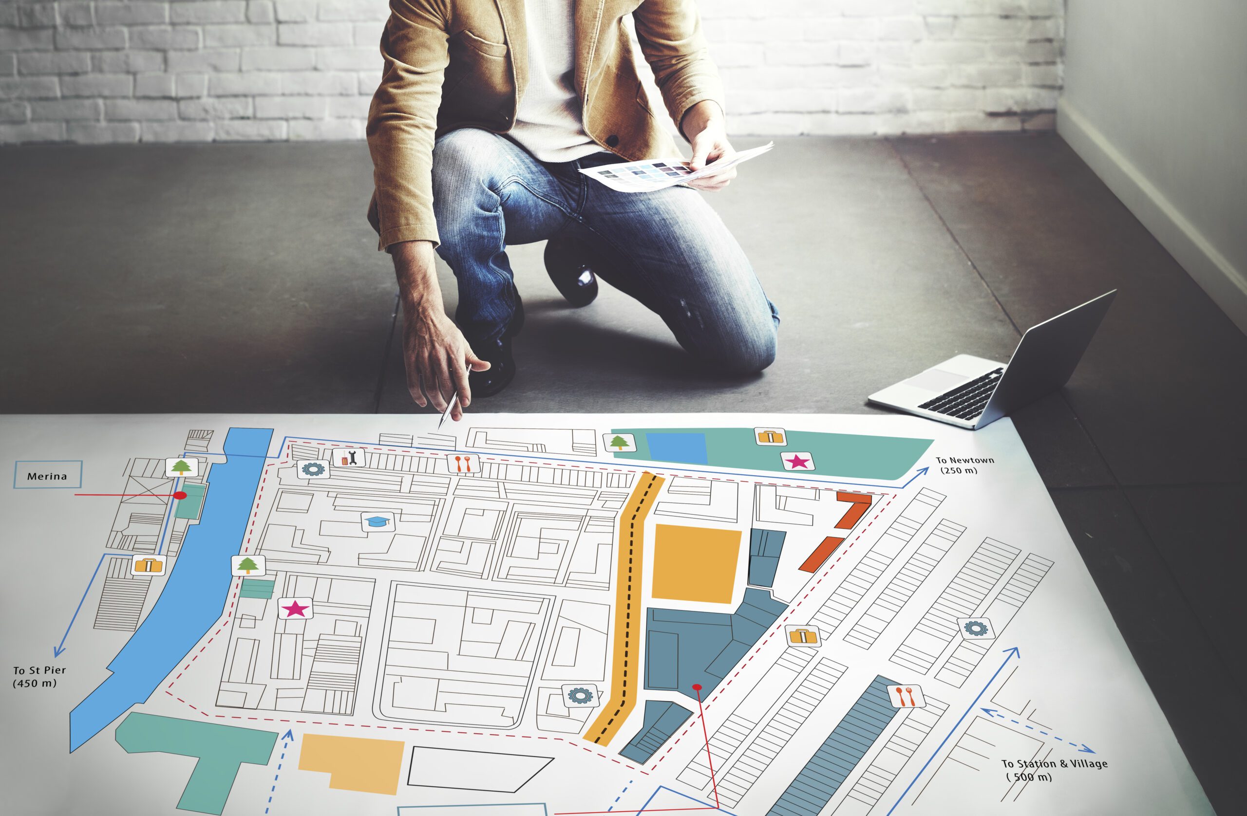 a man is looking at a map of a city.