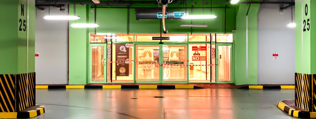 a parking garage with a green door.