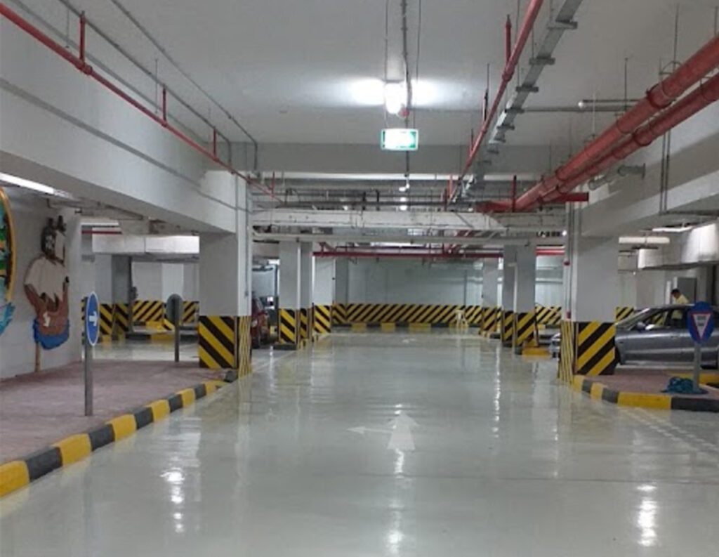 a parking garage with a lot of cars in it.