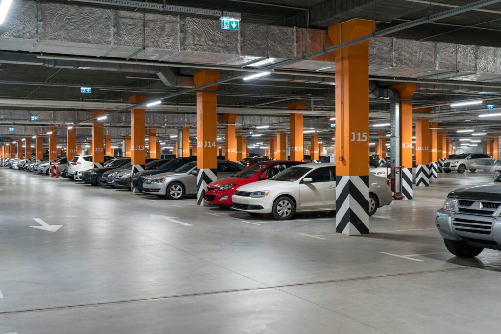a parking garage with many cars parked in it.