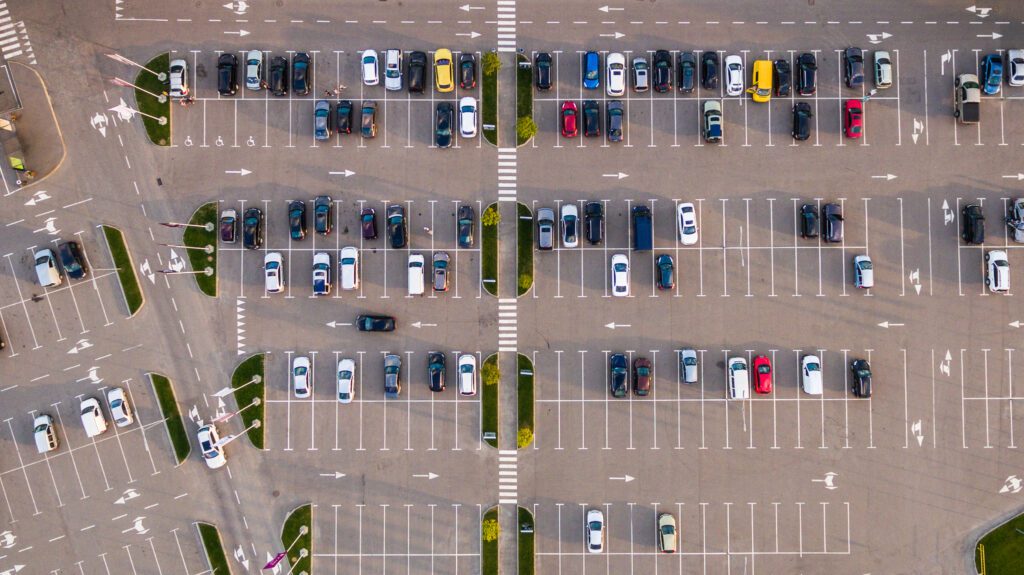 an aerial view of a parking lot full of cars.