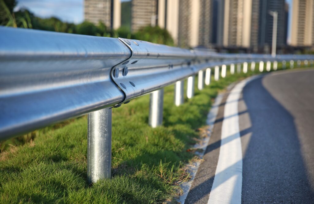 an image of a road with a metal railing.