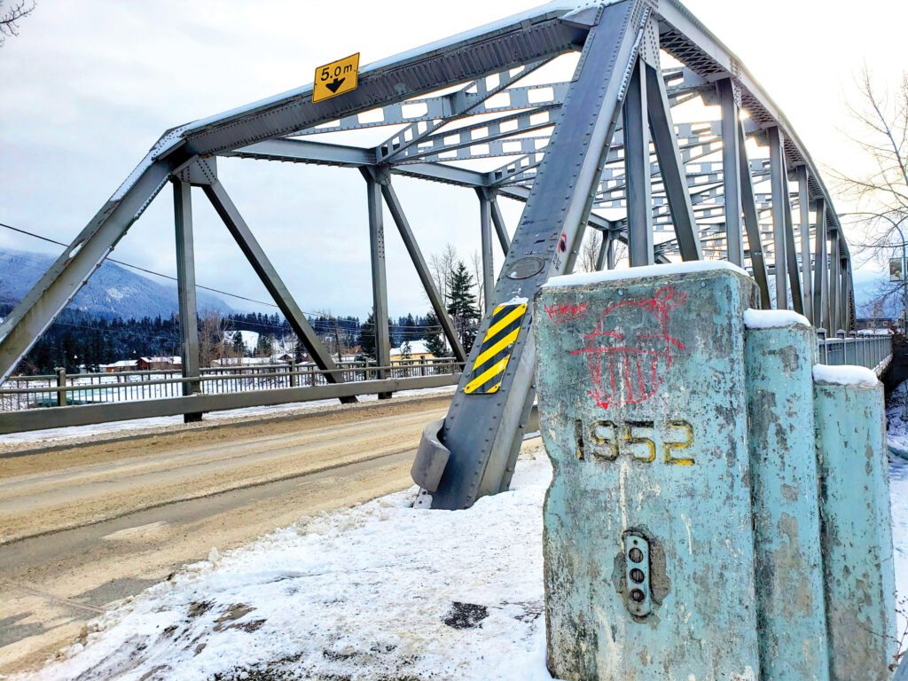 A picture of the existing Kicking Horse Bridge showing signs of deterioration and corrosion.