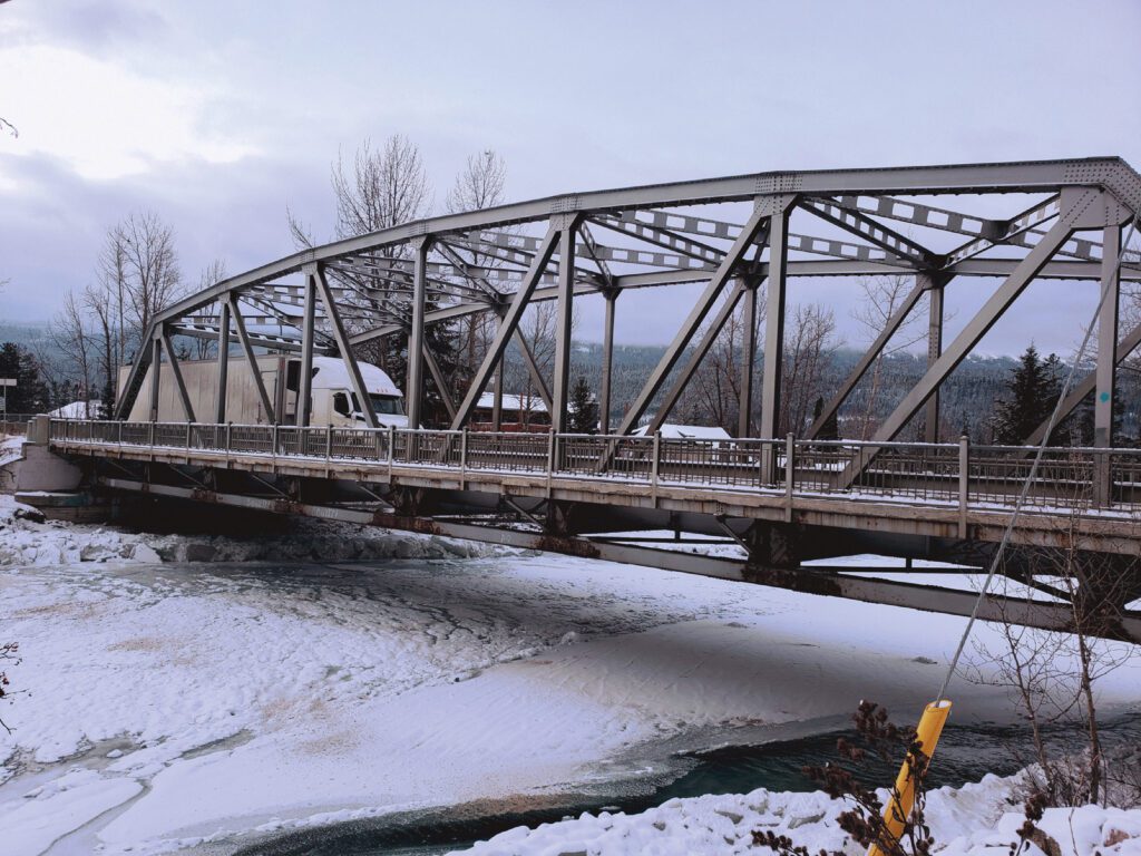 A picture of the existing Kicking Horse Bridge showing signs of deterioration and corrosion.